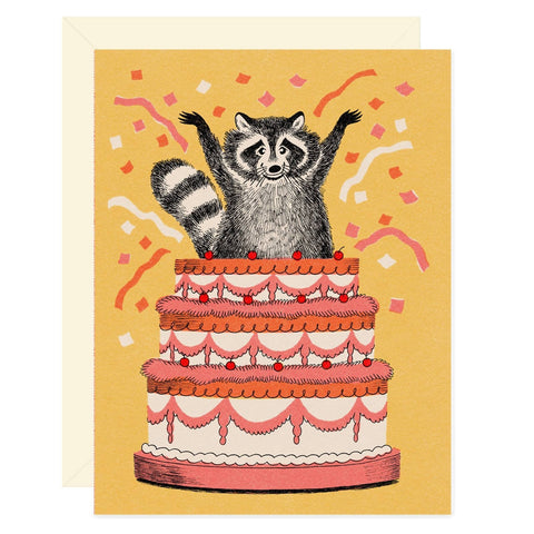 Raccoon birthday cake greeting card from Wallflower Paper & Party, featuring a cute raccoon design and festive cake illustration.