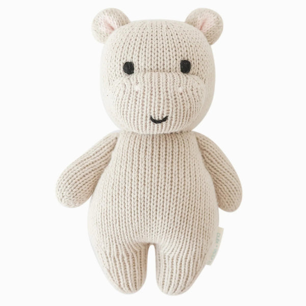 Cuddle + Kind Hippo Mini Hand-Knit Baby Doll with soft pebble-colored yarn and adorable facial features, designed for infants.