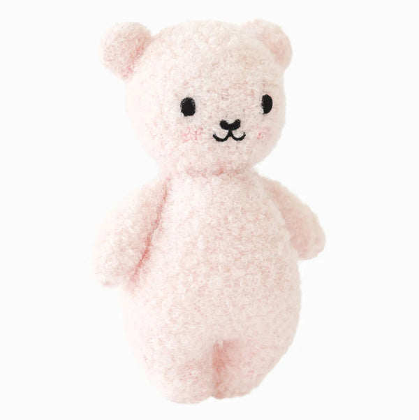 Mini Strawberry Bouclé Bear baby doll by Cuddle + Kind, hand-knit with soft strawberry-colored bouclé fabric.