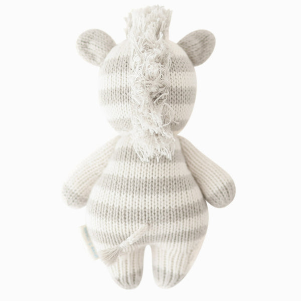 Softly knitted zebra baby doll by Cuddle + Kind, featuring detailed black and white stripes and adorable baby animal design.