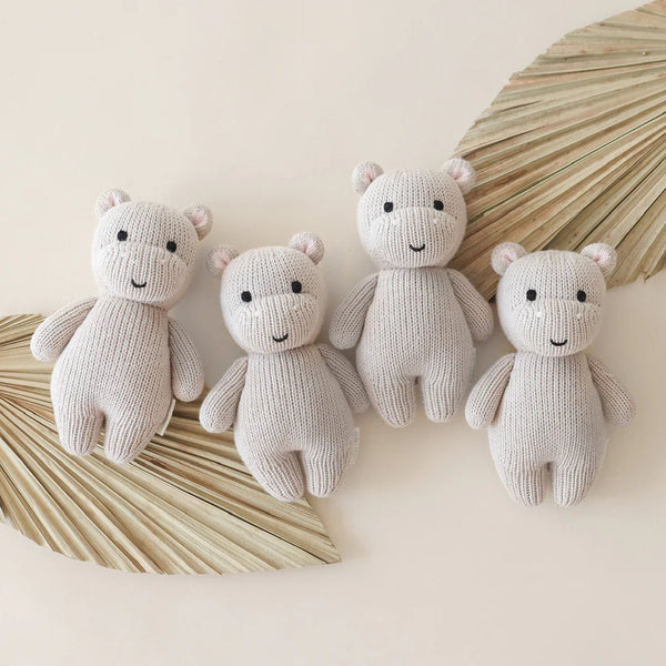 Mini hand-knit Hippo doll for babies by Cuddle + Kind, showing the pebble-colored plush toy with detailed features.