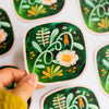 Vinyl sticker from Wild Pencil Studio featuring the "Growing Together" design with colorful, hand-drawn floral and plant illustrations.
