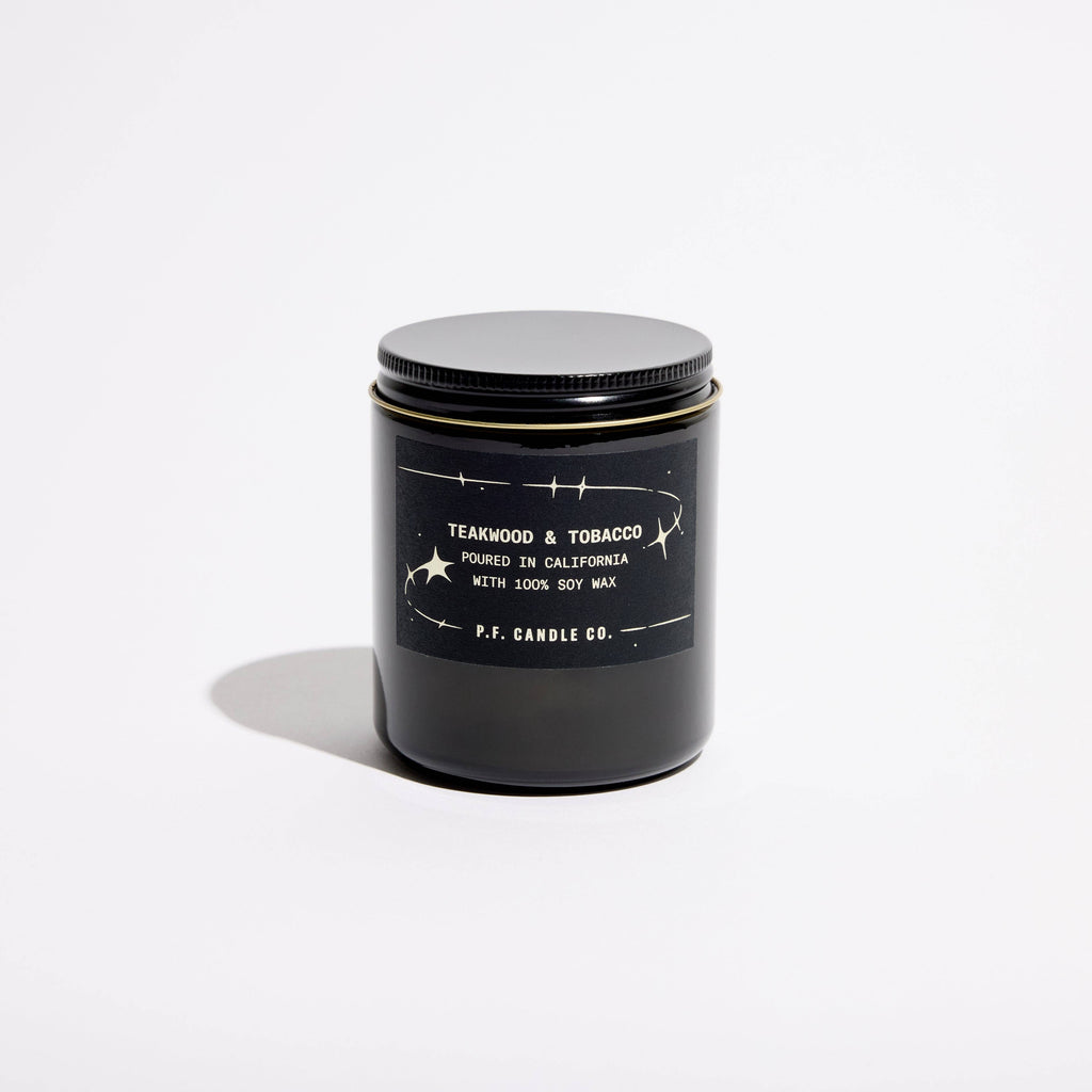 P.F. Candle Co. Teakwood & Tobacco Celestial Collection candle with a simple white container and minimalistic design.