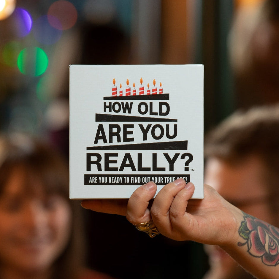 Hygge Games How Old Are You Really? party game box with colorful age-themed design