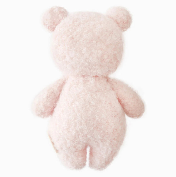 Mini baby hand-knit doll by Cuddle + Kind featuring a strawberry bouclé bear design, soft and adorable for little ones.