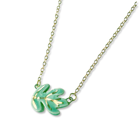 Green and gold ceramic leaf handmade necklace with intricate leaf design, crafted by Crown & Heart.