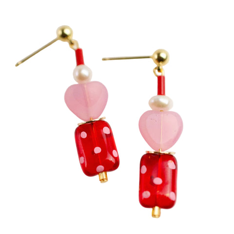 Red and pink polka dot heart earrings by Jill Makes, featuring playful heart-shaped design with polka dot pattern.