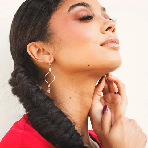 Gold Ogee Earrings by Freshie & Zero featuring lilac and cherry-colored smooth, curved earrings on a neutral background.