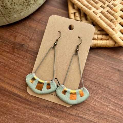 Turquoise and gold ceramic earrings featuring a collar design from The Artifact House, showcasing intricate craftsmanship and vibrant colors.