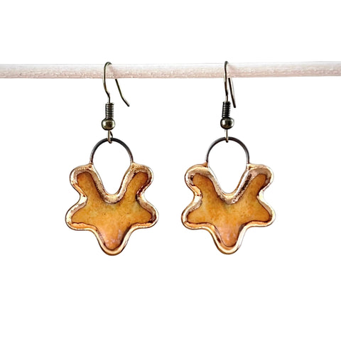 Yellow V flower ceramic earrings by The Artifact House, featuring bright yellow flower-shaped ceramic dangle earrings.