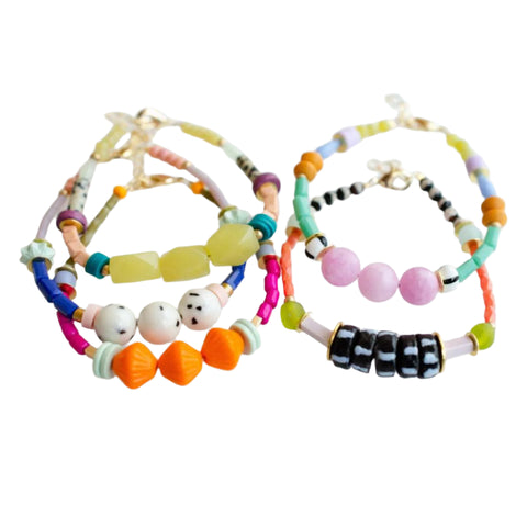 Colorful beaded stacking bracelets by Jill Makes featuring vibrant zinnia-inspired designs and varied bead patterns.