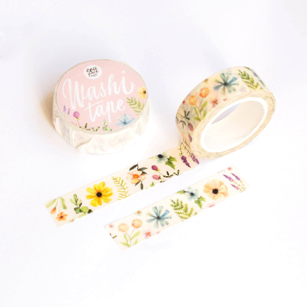 Washi tape with vibrant floral patterns from Wild Pencil Studio, showcasing colorful botanical designs on a roll.