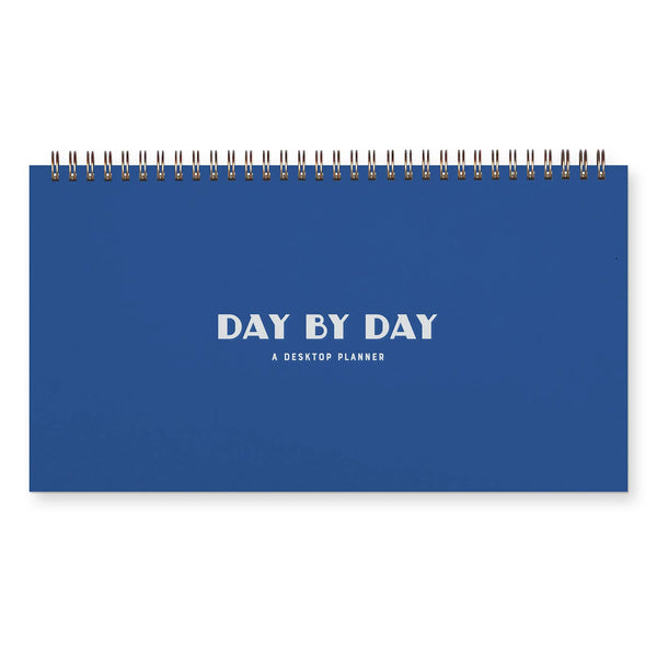 Blue Day By Day Weekly Planner by Ruff House Print Shop with undated calendar pages and weekly layout for organization.