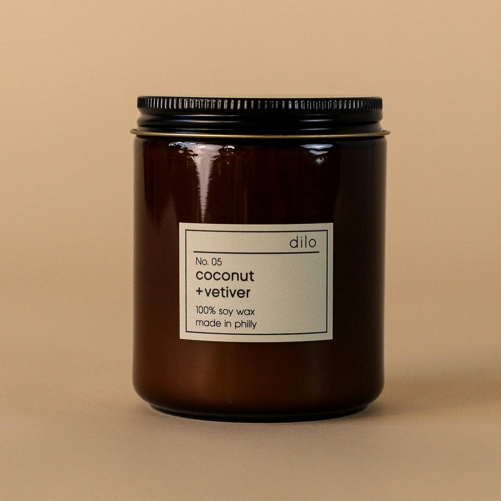 Dilo No. 05 Coconut + Vetiver candle in a glass jar, featuring a natural soy wax blend with coconut and vetiver scents.