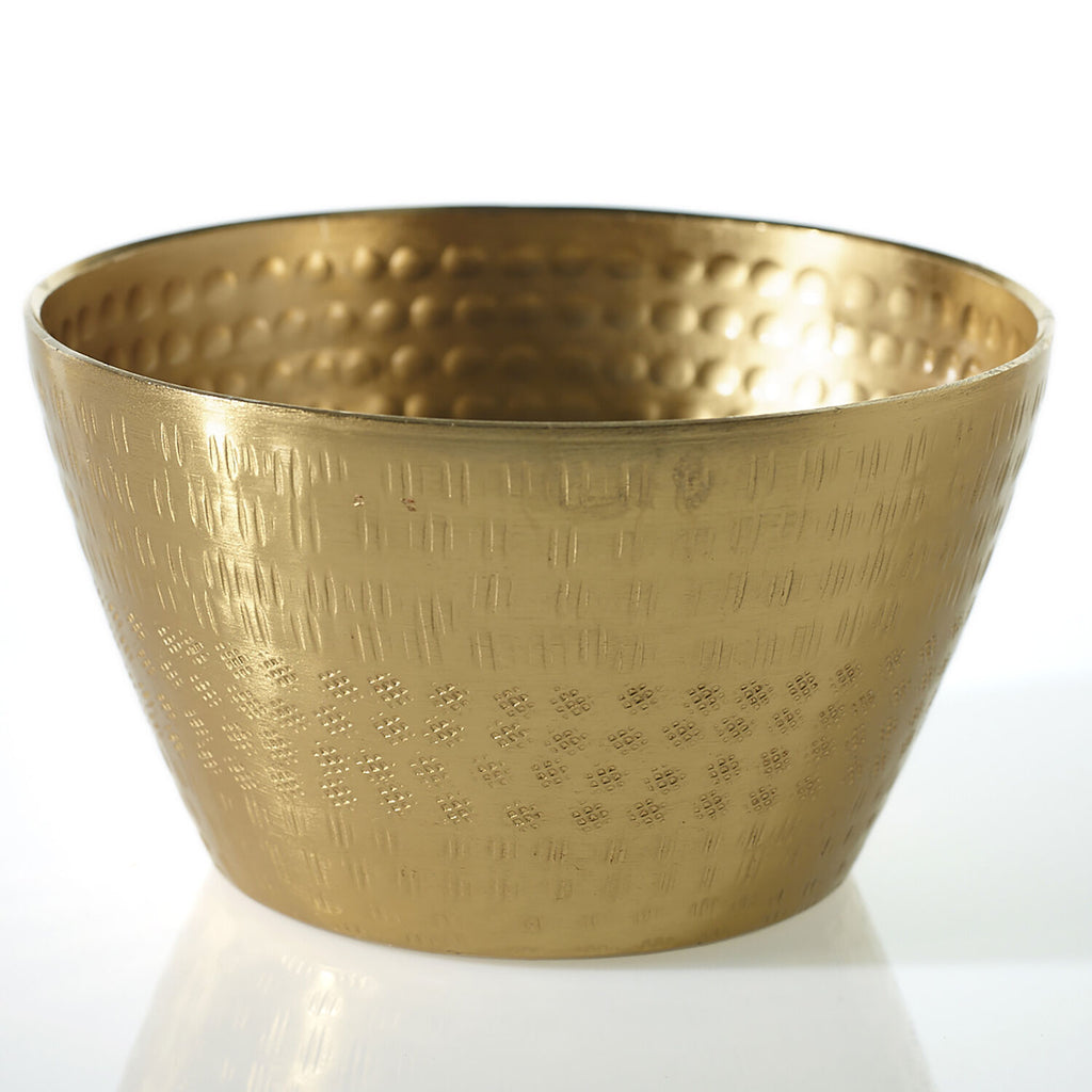 A hammered brass bowl with a textured, metallic finish, photographed on a clean white reflective surface.