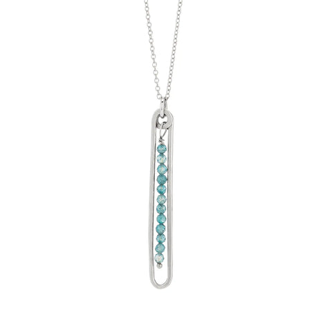 Freshie & Zero Lyric Necklace featuring a blue topaz pendant on a delicate chain, elegant jewelry for sophisticated style.