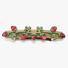 Barrette with strawberry and leaf design on a white background