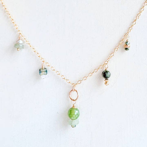 Green seascape gemstone charm necklace featuring vibrant green stones on a delicate chain, styled by Freshie & Zero.