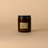 Dilo No. 03 Tobacco + Cedar candle in a glass holder, showcasing the warm, earthy scent and rustic design of the candle.