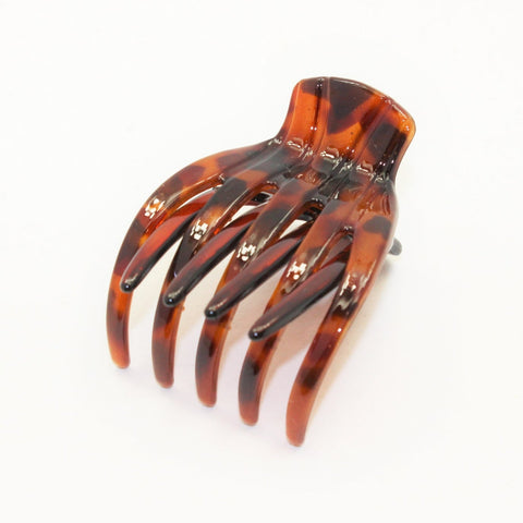 Small Medusa's Heirlooms French Yoga Hair Claw securing hair, showcasing sleek black plastic design with smooth teeth.