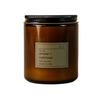 Dilo No. 02 Amber + Oakmoss candle in a clear glass holder, showcasing the warm amber and moss scent profile.