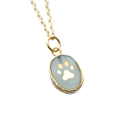 Paw print gemstone necklace by Jill Makes featuring a silver chain and a paw print pendant with colorful gemstones.