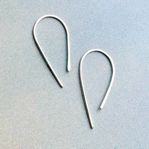Freshie & Zero minimal hoops arch earrings with sleek, simple gold-tone design showcasing elegant curved hoop jewelry.