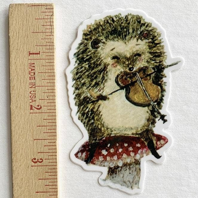 Hedgehog violinist illustrated vinyl sticker by Jahna Vashti, featuring a cute hedgehog playing the violin on a colorful background.