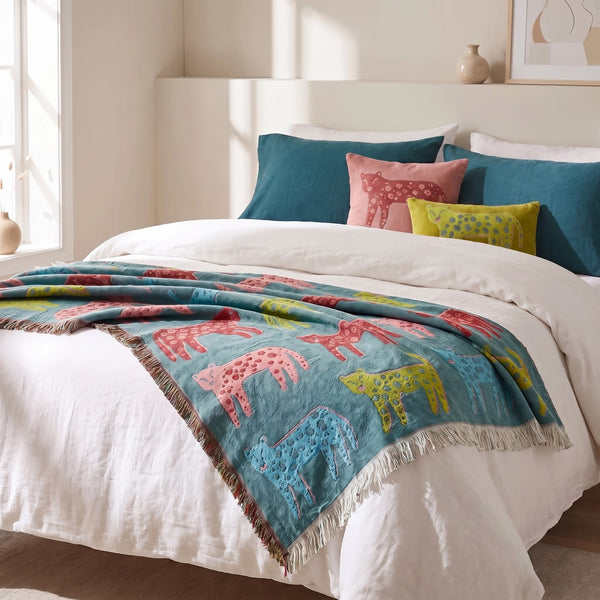 Woven leopard jacquard throw blanket with fringed edges, featuring a bold animal print, by Creative Co-Op.