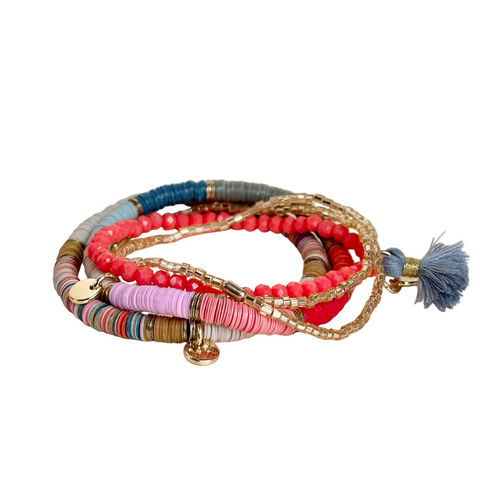 Stacked coral and gold bracelets from Ink + Alloy, featuring delicate gold bangles and coral accents for a stylish layered look.