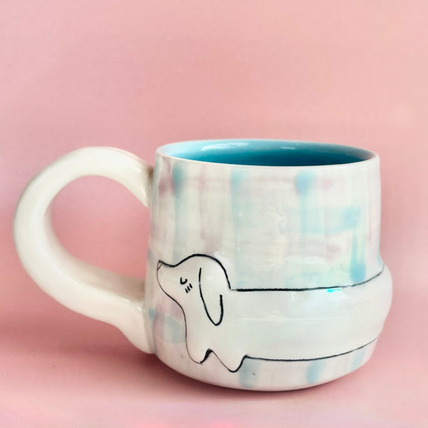 Handmade ceramic plaid dachshund mug with detailed design, by Molly Makes Critters, featuring a whimsical dog shape and colorful plaid pattern.