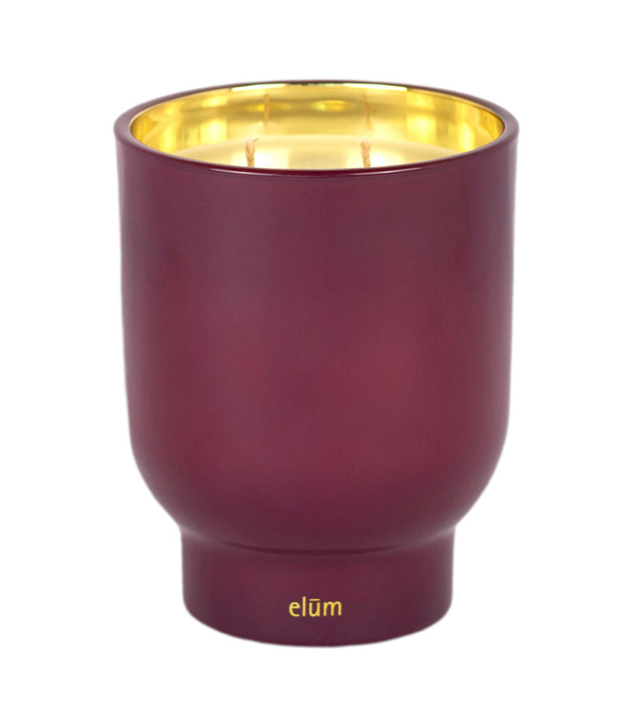 Golden Cuvée 21 oz Maeve glass candle by Elum Designs, featuring a clear glass container with a lit candle inside.