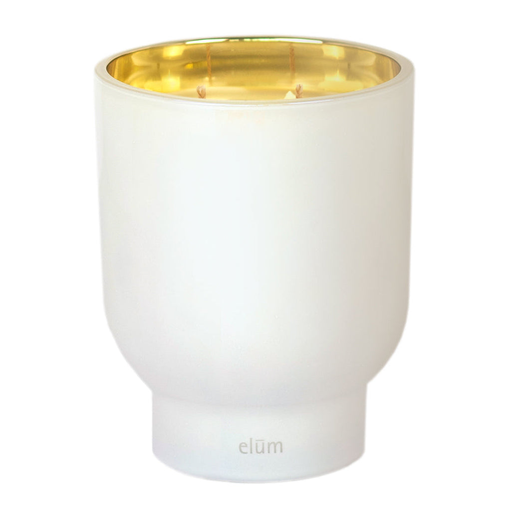 Toasted Vanilla Maeve glass candle in 21 oz container by Elum Designs, featuring a clear glass holder and vanilla scent.