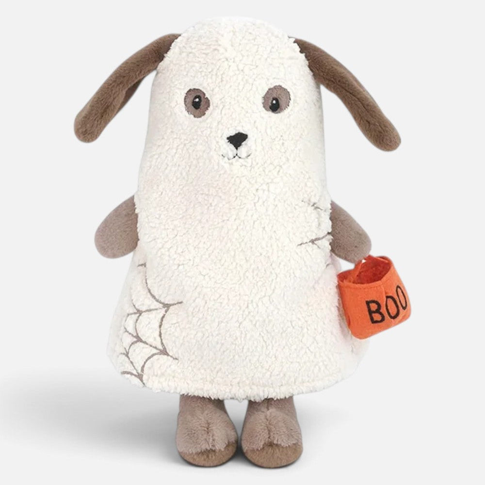 A plush dog toy dressed in a white Halloween gown with brown floppy ears, holding an orange pumpkin bag labeled 'BOO' against a light gray background.