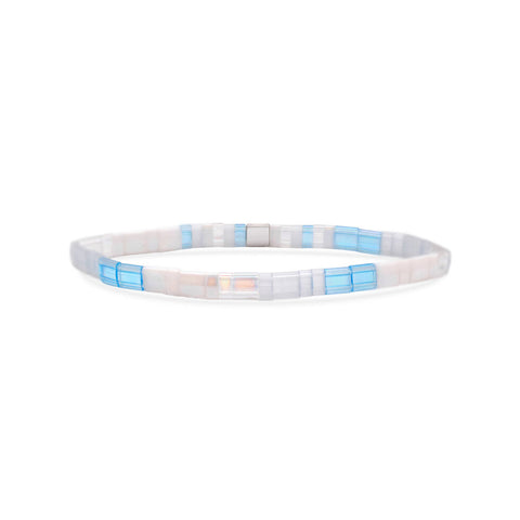 Stia Couture Calm Morse Code Tila bracelet with black beads and silver accents, showcasing a minimalist design on a neutral background.