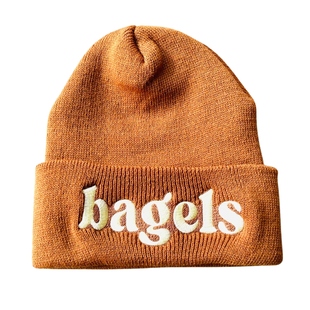 Embroidered silver spider logo on a cozy winter beanie hat, perfect for cold weather from The Silver Spider.