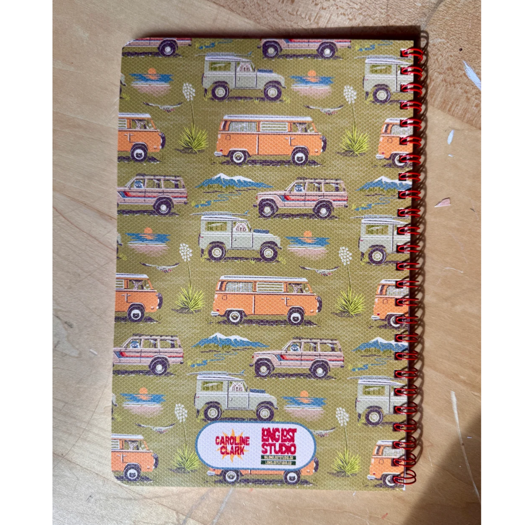 Caroline Clark Camping Trucks Pattern Notebook with colorful truck illustrations on the cover