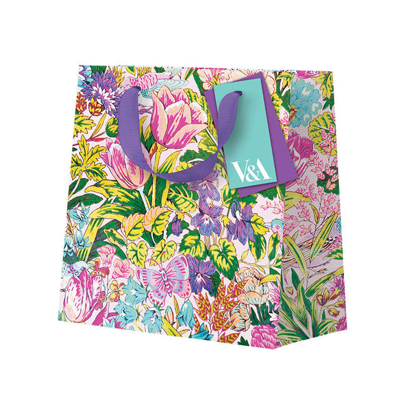 Floral-patterned gift bag with a purple handle on a white background