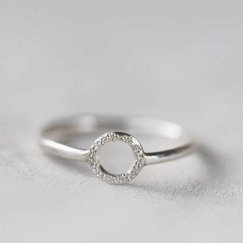 Christina Kober silver ring with diamond dust Karma circle design, featuring a sleek, modern band with textured, sparkling surface.