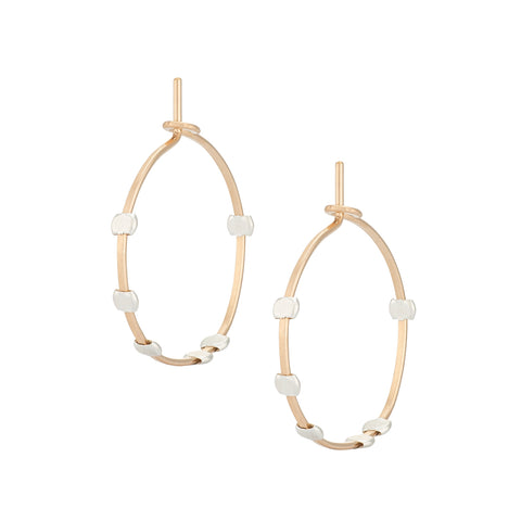 Small minimal cosmos dotted hoop earrings by Freshie & Zero, showcasing delicate gold hoops with tiny dot accents against a neutral background.