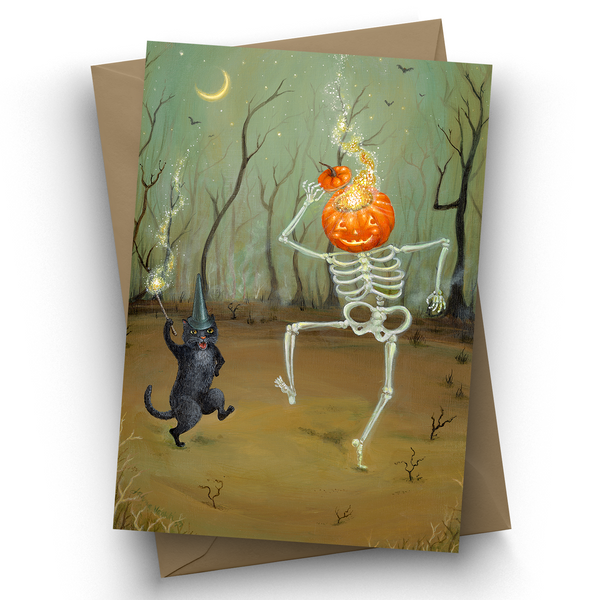 A Halloween-themed art card featuring a skeleton with a glowing jack-o'-lantern head and a black cat wearing a wizard hat, shown with a brown envelope on a white background.