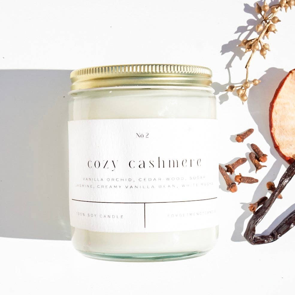 Forget Me Not Candle Cozy Cashmere 9 oz glass candle in a simple clear jar with wax and label