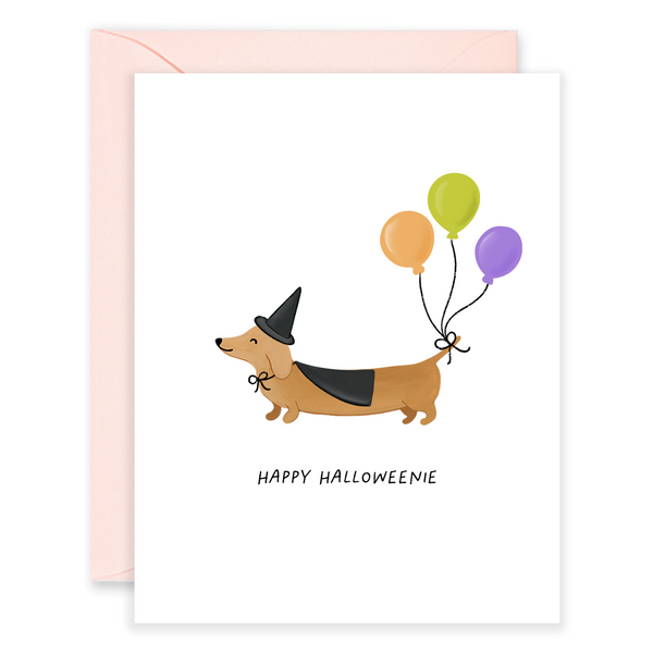 Happy Halloweenie dog greeting card by Isabella MG featuring a festive Halloween dog illustration for Halloween celebrations.