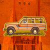 Caroline Clark Camping Cruiser sticker with a colorful outdoor vehicle illustration