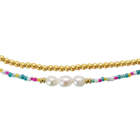 Set of two waterproof anklets by Stia Couture, featuring delicate chain designs perfect for beach or casual wear.