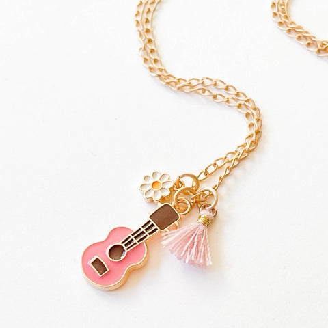 Kids multicharm and tassel necklace by Nest Pretty Things featuring colorful charms and tassels on a delicate chain.