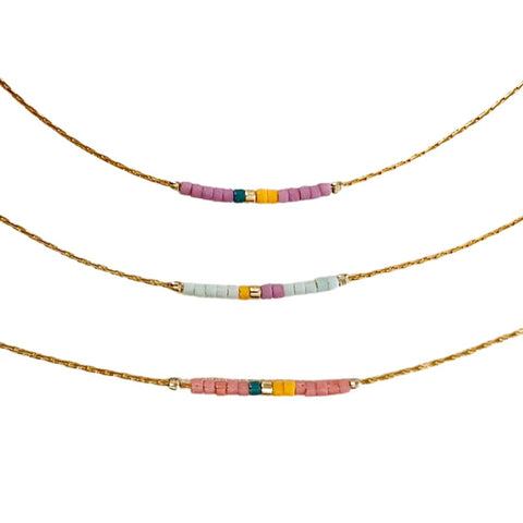 Colorful minimalist beaded necklace from Ocean Breakup featuring small, vibrant beads on a delicate chain.