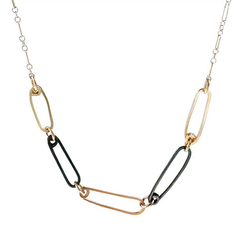 Gold and ink mini reef links necklace by Freshie & Zero featuring delicate reef-shaped chain links.