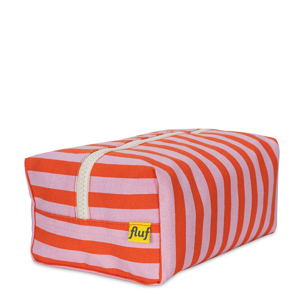 Pink Awning Stripe Traveller Toiletry Bag by Fluf, a compact bag with striped design for travel essentials.