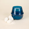 Serene Sea Salt 18 oz Rowan glass candle by Elum Designs with a soft candle flame and textured glass surface.